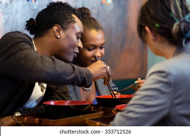 Friends, Black And Latin People, Eating Ramen Noodle Soup In Japanese Restaurant