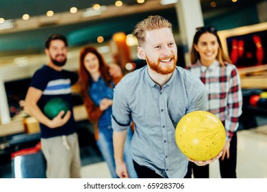 Friends Bowling At Club