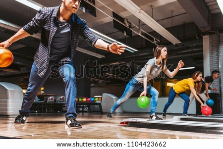 Friends bowling at club and having fun