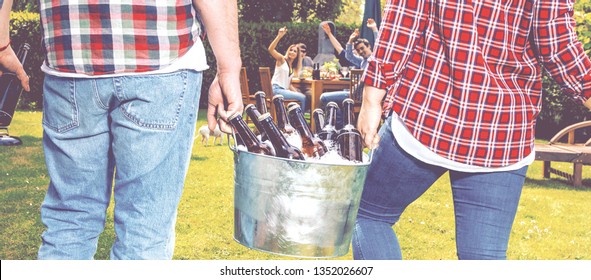 Friends Bring Cold Beer To A Garden Party. Bucket Of Ice And Bottles Of Beer