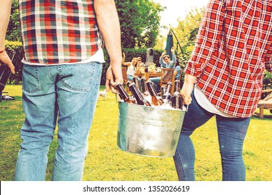 Friends Bring Cold Beer To A Garden Party. Bucket Of Ice And Bottles Of Beer