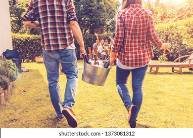 Friends Bring Cold Beer To A Garden Party. Bucket Of Ice And Bottles Of Beer