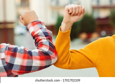 Friends bump elbows outdoors. Coronavirus epidemic. Health care concept. Social distancing. Elbow bump. New greeting style. Coronavirus quarantine. Fight coronavirus. - Powered by Shutterstock