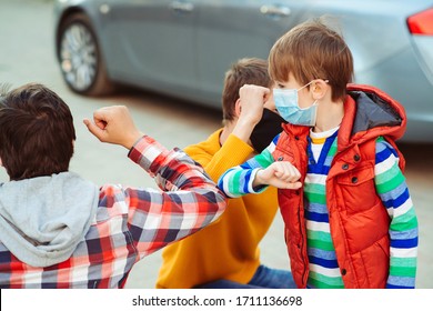 Friends Bump Elbows Outdoors. Health Care Concept. Social Distancing. Father And Children Greeting With Elbows Outdoors. Coronavirus Outbreak. New Way Of Greeting. Coronavirus Quarantine.