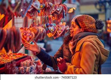 Friends Buying Candies On Christmas Market