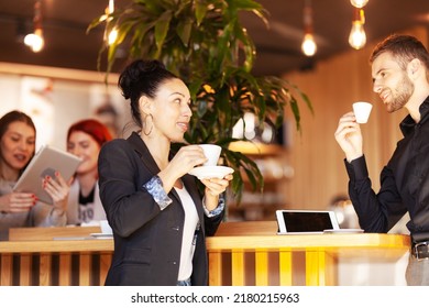 Photo of Friends at a cafe having coffee and chatting. Successful young people