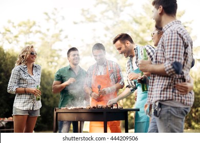 Friends camping and having a barbecue in nature