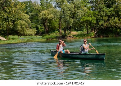 friends are canoeing in a wild river