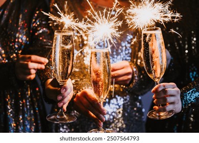 Friends celebrating Christmas or New Year eve party with Bengal lights and champagne. - Powered by Shutterstock