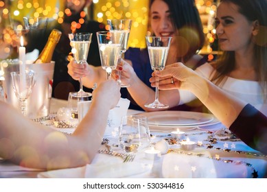 Friends Celebrating Christmas Or New Year Eve. Party Table With Champagne.