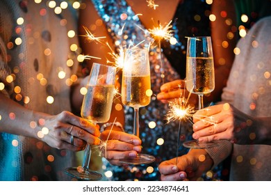 Friends celebrating Christmas or New Year's eve with Bengal lights and champagne.


 - Powered by Shutterstock