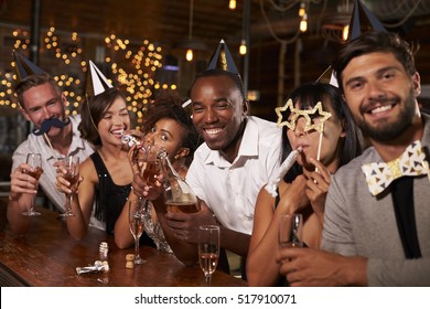 Friends Celebrating New Year Eve At A Party In A Bar