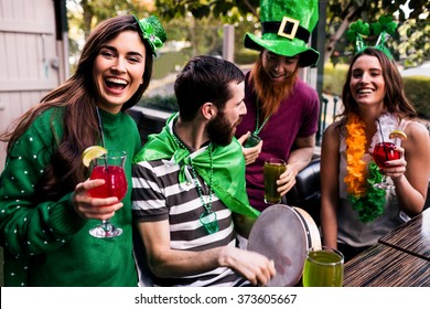 Friends celebrating St Patricks day with drinks in a bar