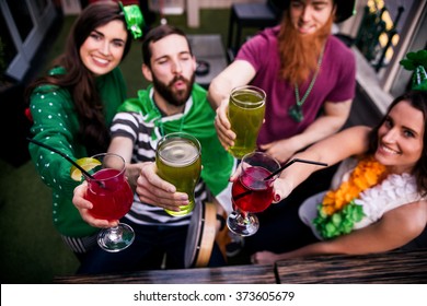 Friends Celebrating St Patricks Day With Drinks In A Bar