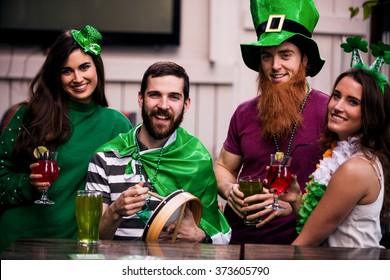 Friends Celebrating St Patricks Day With Drinks In A Bar