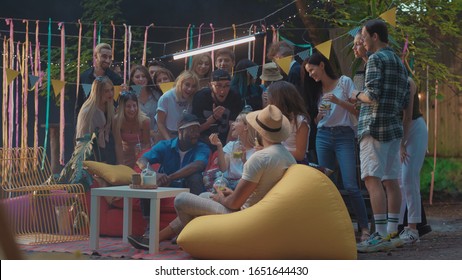 Friends Celebration Party. Happy Young People Chilling Looking At Oint Polaroid Photo Laughing Of Fun. Hangout. Summertime.