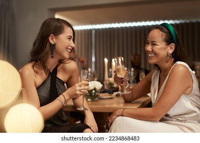 Friends, champagne and women in restaurant, party and dinner for bonding. New Years, females and girls enjoy drink, smile and conversation for celebration, bond and happy at social event to relax. - Powered by Shutterstock