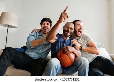 Friends cheering sport league together - Shutterstock ID 1303781251