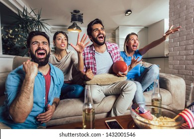 Friends cheering sport league together on tv and celebrating victory at home.Friendship, sports and entertainment concept. - Shutterstock ID 1432001546