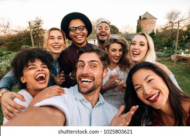 Friends Chilling Outside Taking Group Selfie And Smiling. Laughing Young People Standing Together Outdoors And Taking Selfie.