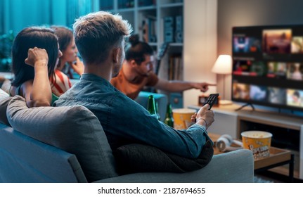 Friends choosing a movie to watch together at home, video on demand concept - Shutterstock ID 2187694655