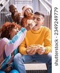 Friends, city and feeding food outdoor for happiness, funny laugh and fun on stairs. Diversity, eating and gen z group of men and women with a hotdog on a date, adventure and freedom in urban town