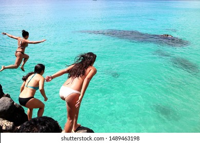 Friends Cliff Jumping Into The Ocean, Summer Fun Lifestyle. Diving Cliff Ocean.