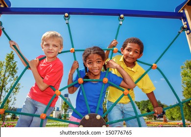 Friends climbing the net at the playground