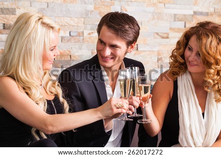 friends clinking glasses at a party
