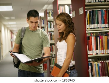 Friends Comparing Notes In A School Library