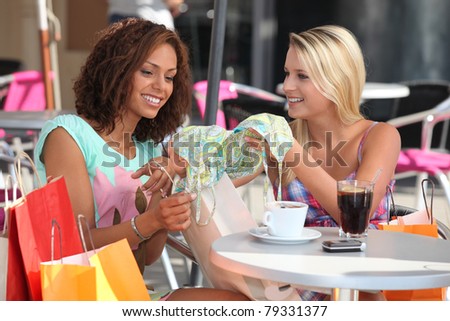 Friends comparing purchases in a cafe