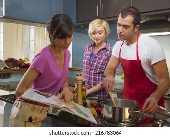 Friends Cooking In The Kitchen.