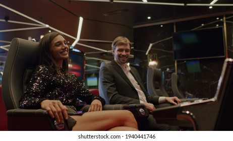 Friends Or Couple Enjoying Playing The Slot Machine At The Elite Casino. Gambling, Nightlife