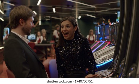 Friends Or Couple Enjoying Playing The Slot Machine At The Elite Casino. Gambling, Nightlife