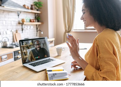 A friends or coworkers are talking online via video. A biracial girl is using laptop for video call to an African-Americam guy. Video conference - Shutterstock ID 1777853666