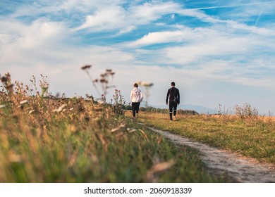 Friends With Dog On Walk In Beautiful Rural Nature In A Landscape Behind Village. Enjoying Autumn Day And Leisure Time. Young People 