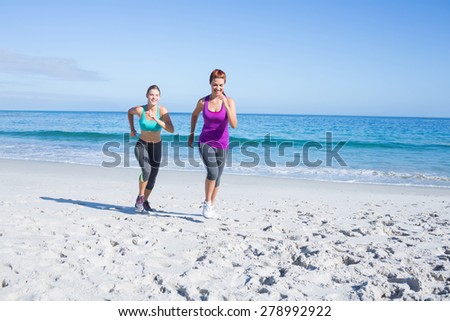 Friends doing jogging together at the beach