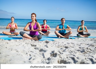 Friends Doing Yoga Together At The Beach