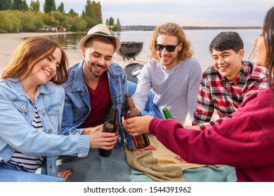 Friends drinking beer at barbecue party near river - Shutterstock ID 1544391962