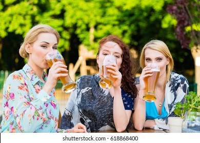 Friends Drinking In Beer Garden Restaurant