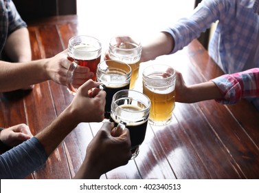 Friends Drinking Beer In Pub