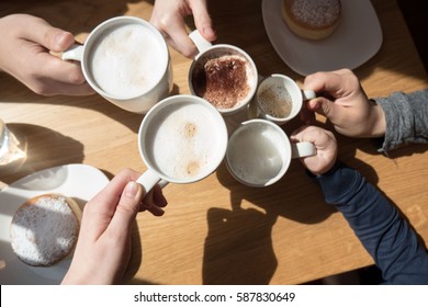 Friends Drinking Coffee In Cafe. Family Get Rest Together With A Cup Of Coffee. Happy Family Sunny Day In Cafe.