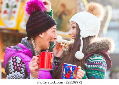 Friends Drinking Eggnog On Christmas Market 