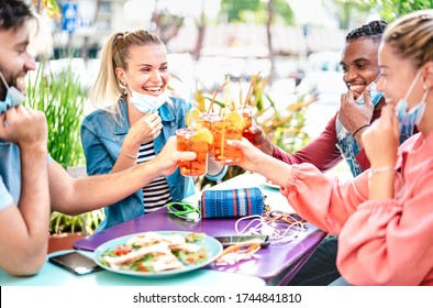 Friends Drinking Spritz At Cocktail Bar With Open Face Mask - New Normal Friendship Concept With Happy People Having Fun Together Toasting Drinks At Restaurant - Bright Filter With Focus On Left Woman