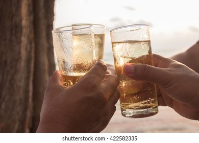 Friends Drinking Whiskey On Party On The Beach.