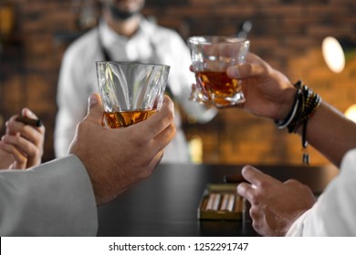 Friends Drinking Whiskey Together In Bar, Closeup