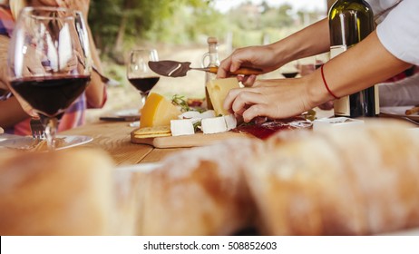Friends Drinking Wine And Eating Cheese