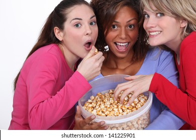 Friends eating caramel popcorn together