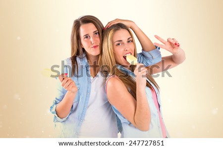Friends eating ice cream over ocher background