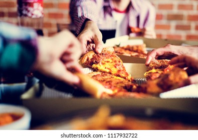 Friends Eating Pizza Together At Home